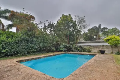 a swimming pool in the backyard of a house at Crowley Cottage in White River