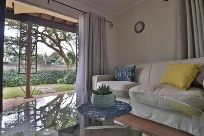 a living room with a couch and a table at Crowley Cottage in White River
