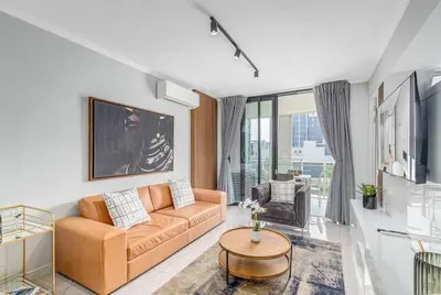 a living room with a couch and a table at 2 Bed Luxury Apartment, Ellipse, Waterfall in Midrand