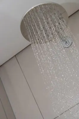 a shower head in a bathroom with crystals on the ceiling at 2 Bed Luxury Apartment, Ellipse, Waterfall in Midrand