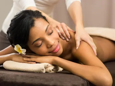 a woman laying on a couch receiving aorative massage at Dikhololo in Brits