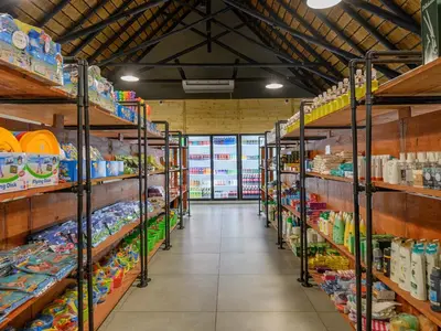 a aisle of a store with many shelves of food at Dikhololo in Brits