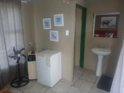 a bathroom with a fan and a sink at Mbaula lodge in Letaba Wildlife Reserve