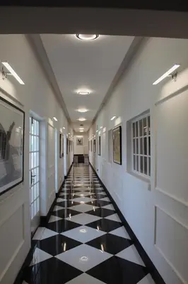 a hallway with a black and white tiled floor at Kingdoms Lodge in Groblersdal