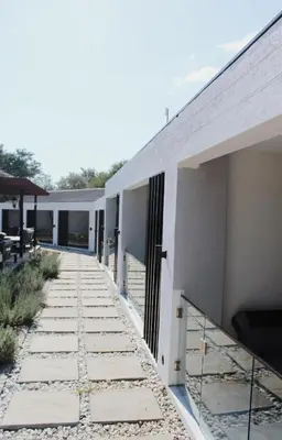 a walkway next to a white building at Kingdoms Lodge in Groblersdal