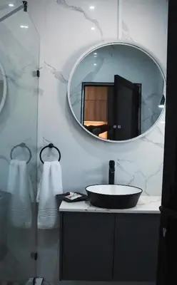a bathroom with a sink and a mirror at Kingdoms Lodge in Groblersdal
