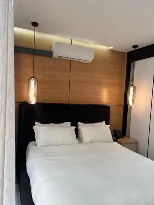 a bedroom with a large bed with two white pillows at Kingdoms Lodge in Groblersdal