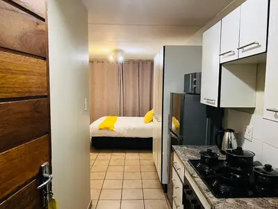 a small kitchen with a bed in a room at Mbizo Cozy Retreat 307 in Pretoria