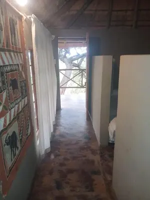 a hallway leading to a room with a door at Mbaula lodge in Letaba Wildlife Reserve