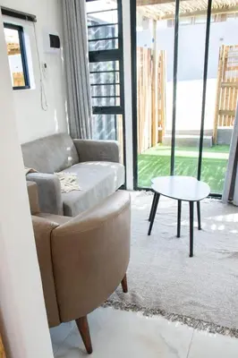 a living room with a couch and a table at Cozy Box Haus in Graskop