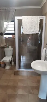 a bathroom with a toilet and a sink at Malikana Guesthouse in Kempton Park