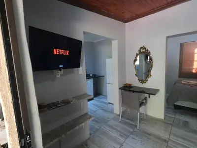 a bedroom with a bed and a television on the wall at Makhonjwa Rose Barberton in Barberton