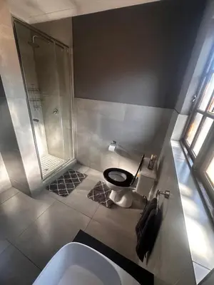 a bathroom with a toilet and a shower and a sink at 53 Bela-Bela Pendleberry Grove Holiday Resort Unit 53 in Bela-Bela