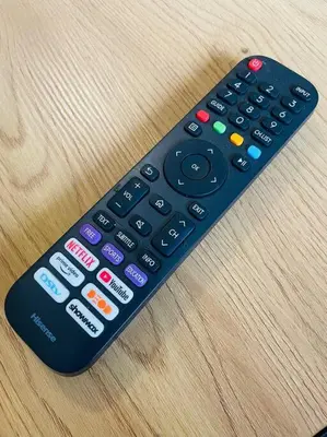 a remote control sitting on top of a wooden table at Waterfall Ridge Premium Apartments in Midrand
