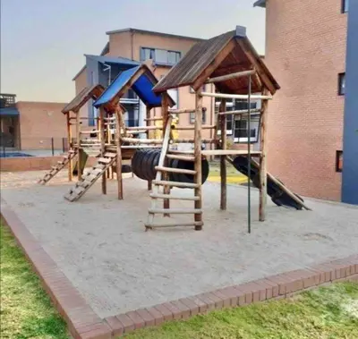 a playground with slides and a play structure at Waterfall Ridge Premium Apartments in Midrand