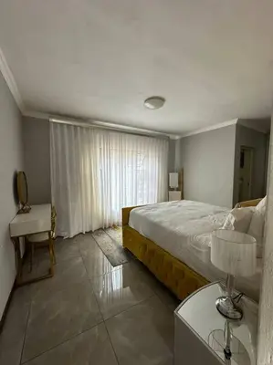 a bedroom with a bed and a table with a lamp at LaRo in Boschrand
