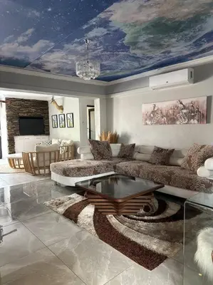 a living room with a couch and a table at LaRo in Boschrand