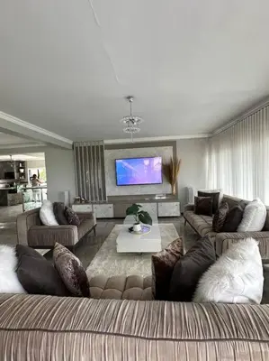 a living room with couches and a flat screen tv at LaRo in Boschrand