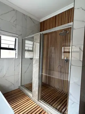 a shower with a glass door in a bathroom at LaRo in Boschrand