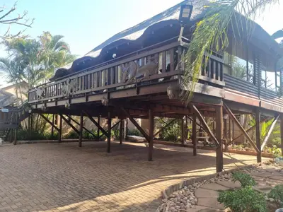 a train on a wooden bridge over a street at Wooden Log House in Bela-Bela