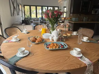 a wooden table with plates of food on it at Luxury Escape - Pecanwood Golf Estate - Hartbeespoort in Hartbeespoort