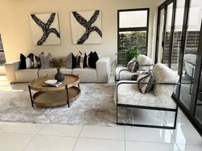a living room with a couch and a coffee table at Luxury Escape - Pecanwood Golf Estate - Hartbeespoort in Hartbeespoort