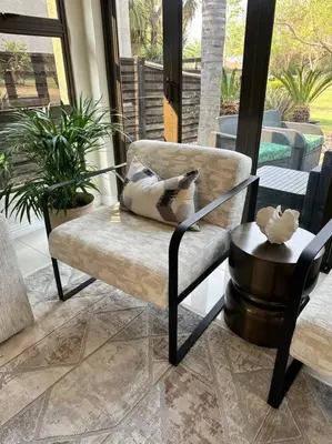 a chair with a pillow on it in a porch at Luxury Escape - Pecanwood Golf Estate - Hartbeespoort in Hartbeespoort