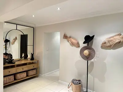 a room with a mirror and a hat on a wall at Luxury Escape - Pecanwood Golf Estate - Hartbeespoort in Hartbeespoort