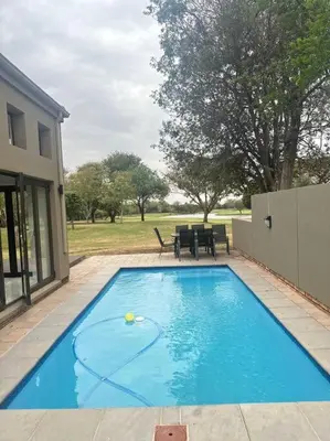 a swimming pool with a tennis ball in the middle at Luxury Escape - Pecanwood Golf Estate - Hartbeespoort in Hartbeespoort