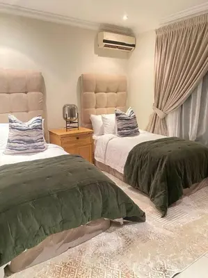 a bedroom with two beds and a window at Luxury Escape - Pecanwood Golf Estate - Hartbeespoort in Hartbeespoort