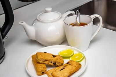 a plate of food with a teapot and a cup of tea at Urban Luxe by Jules, Ellipse, Waterfall in Midrand