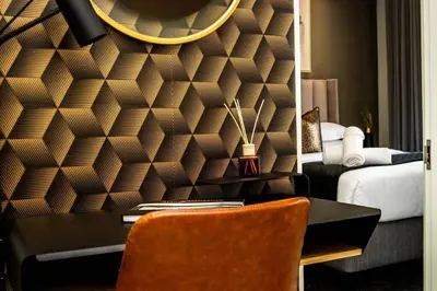 a room with a desk and a bedroom with a bed at Urban Luxe by Jules, Ellipse, Waterfall in Midrand