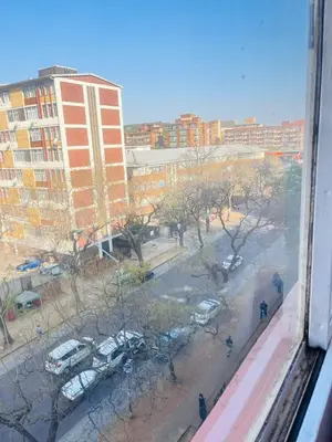 a view of a city with cars parked in a parking lot at Palm Rest in Pretoria