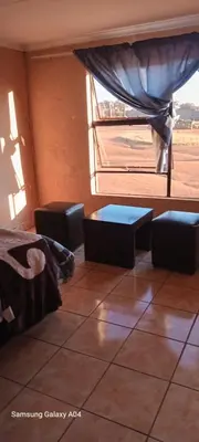 a room with a bed and a large window at Masha accomodation in Jane Furse
