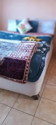 a bed sitting on top of a tiled floor at Masha accomodation in Jane Furse