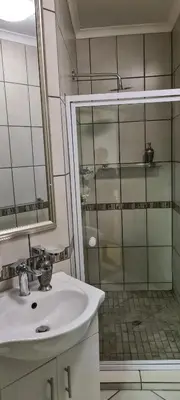 a bathroom with a sink and a shower at Upstairs R-1 Self-Catering Unit in White River