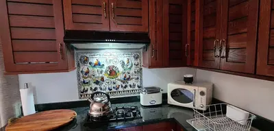 a kitchen with wooden cabinets and a counter top at Upstairs R-1 Self-Catering Unit in White River