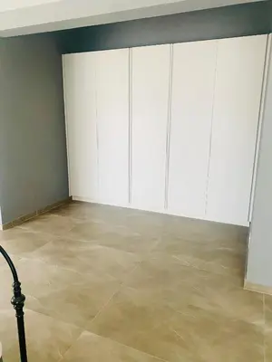 a room with white cabinets and a tile floor at Zinnia house in Midrand