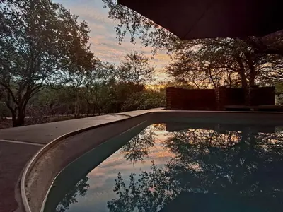 a reflection of the sky in a swimming pool at Erdvark Bosbreek in Marloth Park