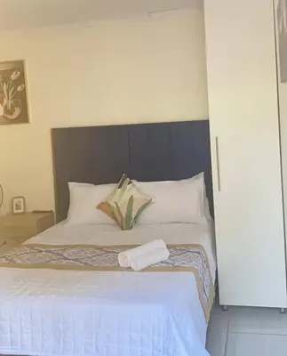 a bed with two towels on top of it at Giraffe camel in Phalaborwa