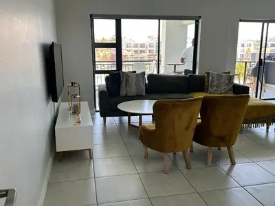 a living room with a couch and a table at The Blyde Penthouse in Pretoria