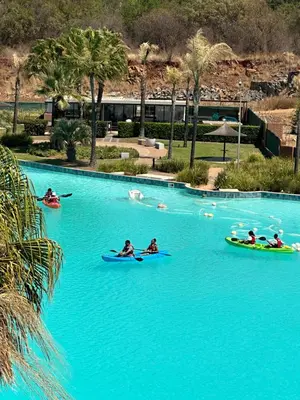 a group of people in kayaks in a pool of blue water at The Blyde Penthouse in Pretoria