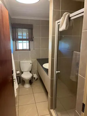 a bathroom with a toilet and a sink at Kruger Park Lodge, Mpumalanga Unit 424 in Hazyview