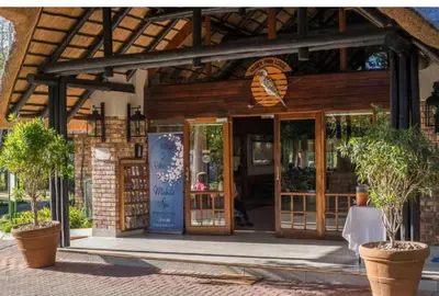 a store front with glass doors and potted plants at Kruger Park Lodge, Mpumalanga Unit 424 in Hazyview
