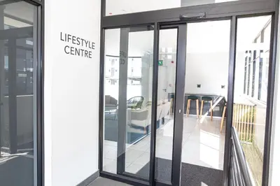 an entrance to a building with sliding glass doors at Waterkloof on Main Sassy Modern Apartment in Pretoria