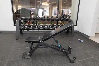 a bench in a gym with a lot of equipment at Waterkloof on Main Sassy Modern Apartment in Pretoria