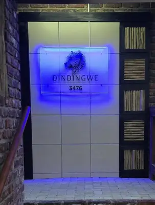 a door with a sign that reads dunder mifflin at Dindingwe in Marloth Park