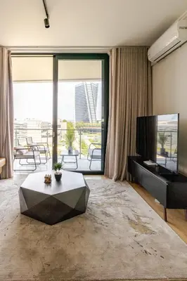 a living room with a television and a table at Neria at Ellipse Waterfall in Midrand
