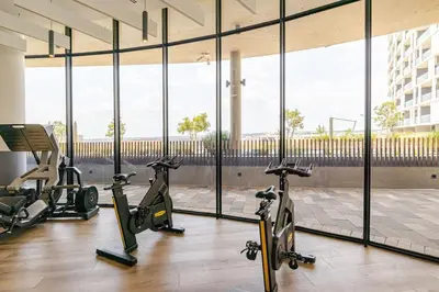a gym with three exercise bikes in a building at Neria at Ellipse Waterfall in Midrand