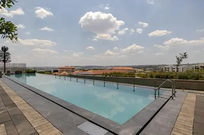 a swimming pool on the roof of a building at Neria at Ellipse Waterfall in Midrand